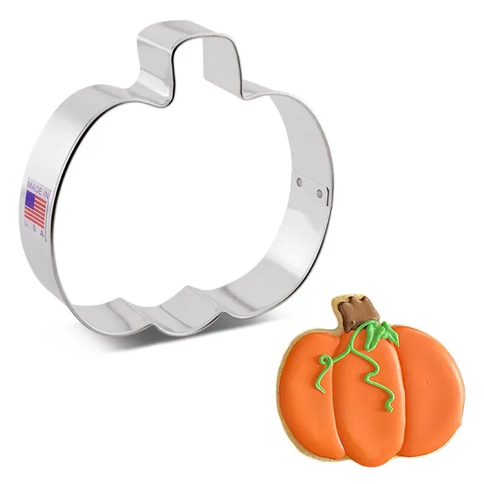Pumpkin cookie cutter with a decorated cookie